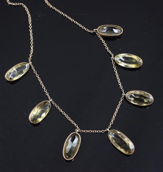 An early 20th century 9ct gold and citrine drop necklace, 21in.